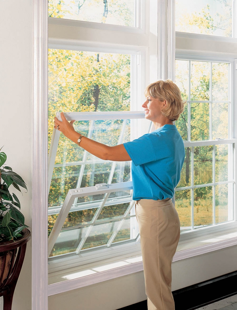 New Replacement Windows From Echols Home Improvement, Atlanta woman with replacement windows that tilt for easy cleaning